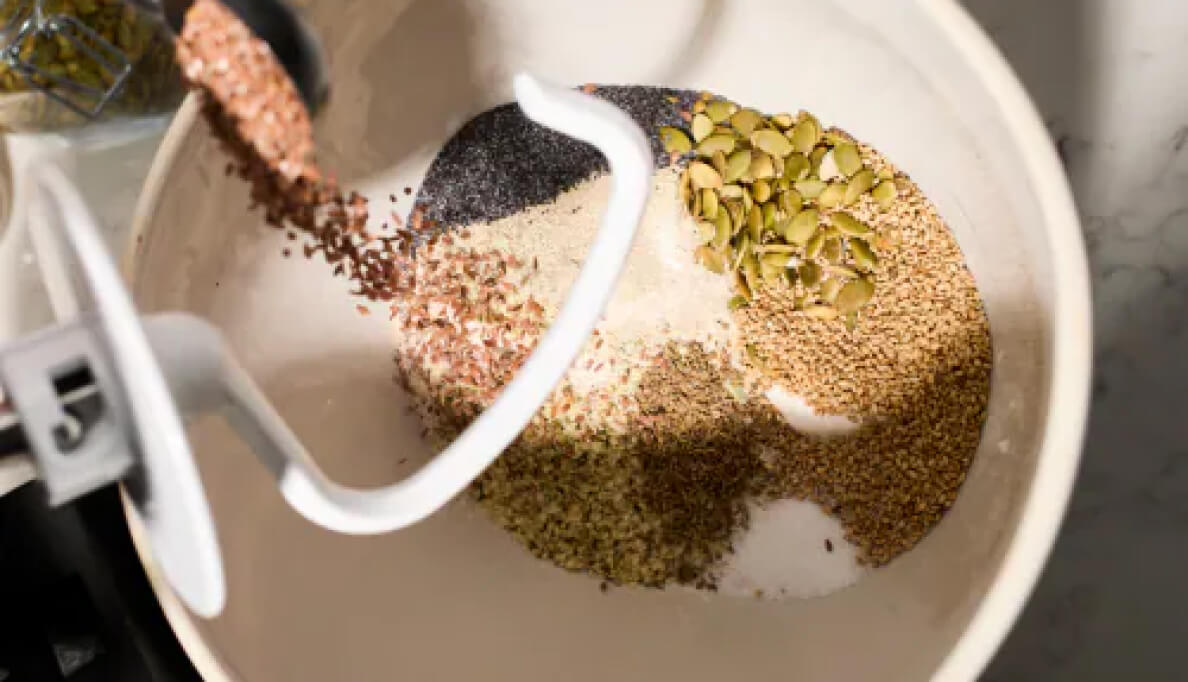 A variety of grains in the bowl of a stand mixer.