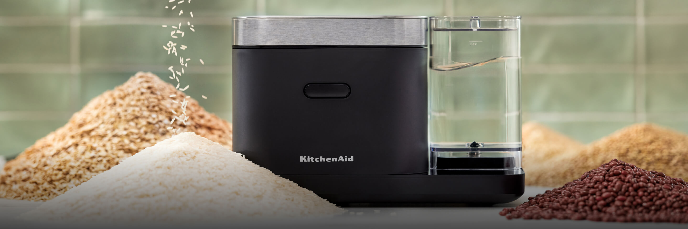 A closed grain and rice cooker with small mountains of rice and grains surrounding it.