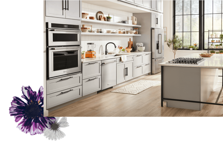 A white kitchen filled with a suite of stainless steel KitchenAid® appliances.