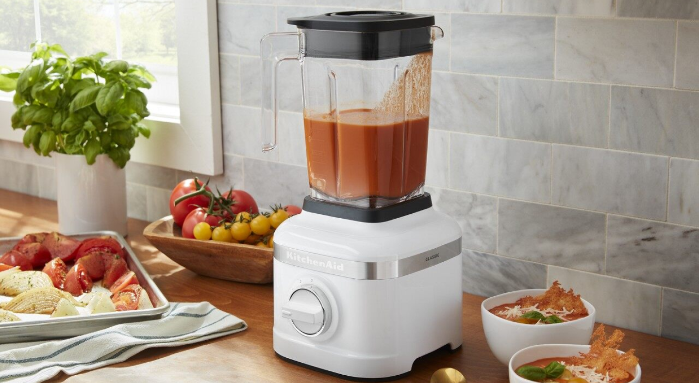 Same as Image Alt Text White KitchenAid® countertop blender filled with orange soup