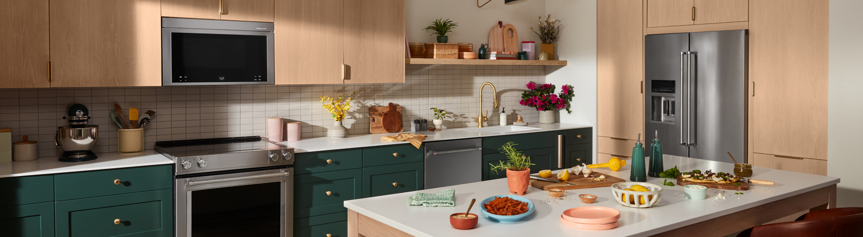 A kitchen with green cabinets and various ingredients on the counter