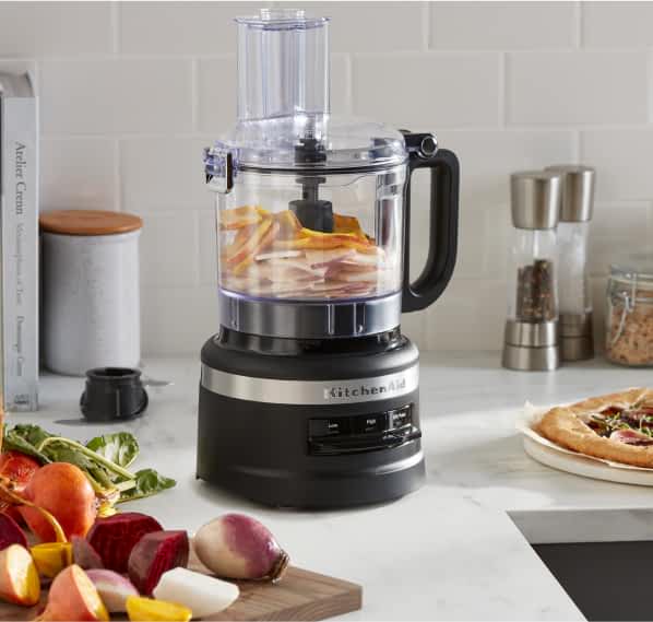A KitchenAid® Food Processor blending vegetables.