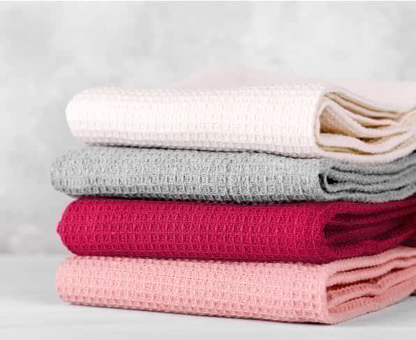 Different linens in shades of pink and gray.