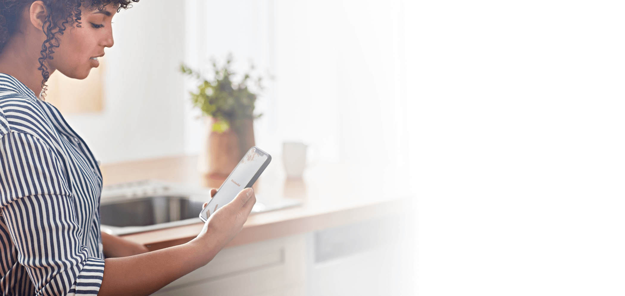 A woman familiarizing herself with her new KitchenAid™ app.