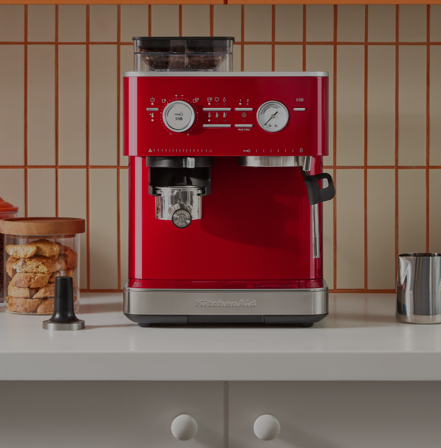 A red KitchenAid® espresso machine on a countertop.
