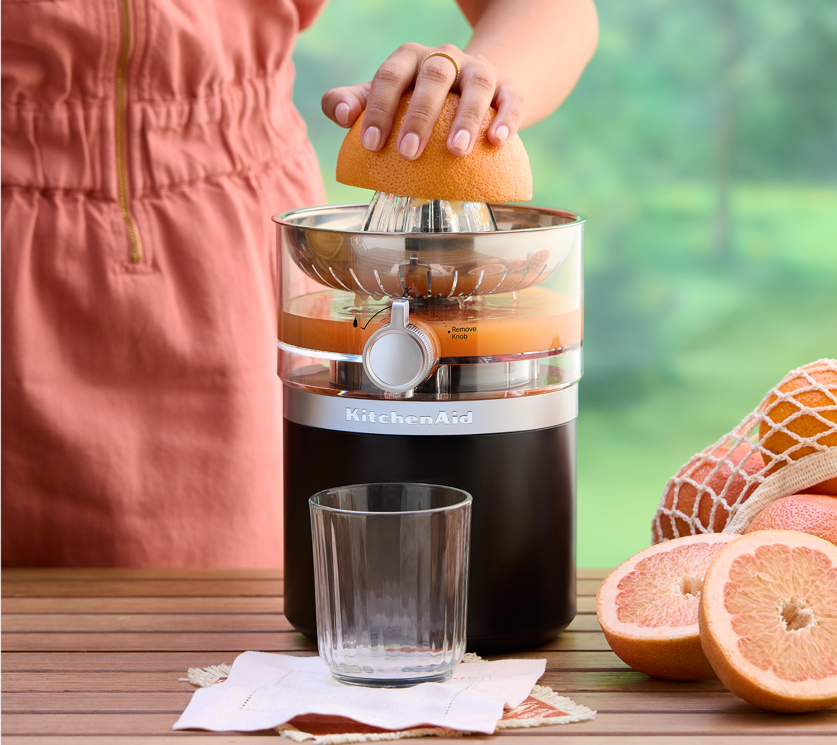 A person using the KitchenAid Go™ Cordless Citrus Juicer to juice oranges. 