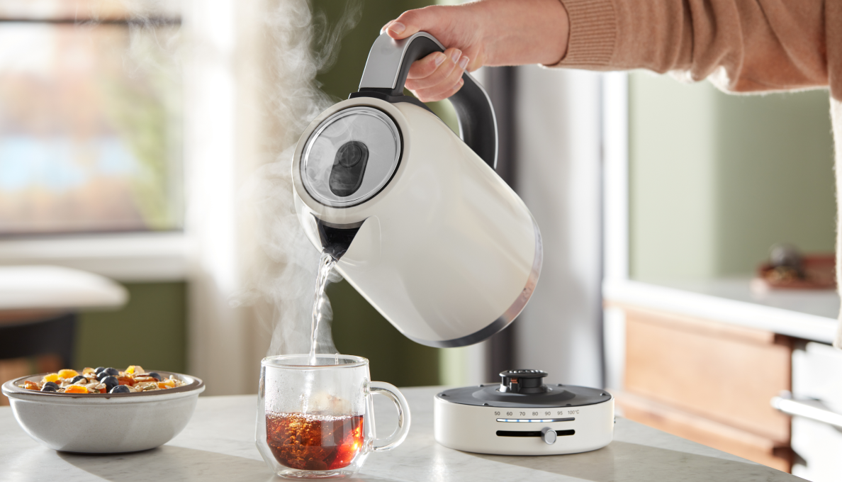 A person pouring hot water into oats.