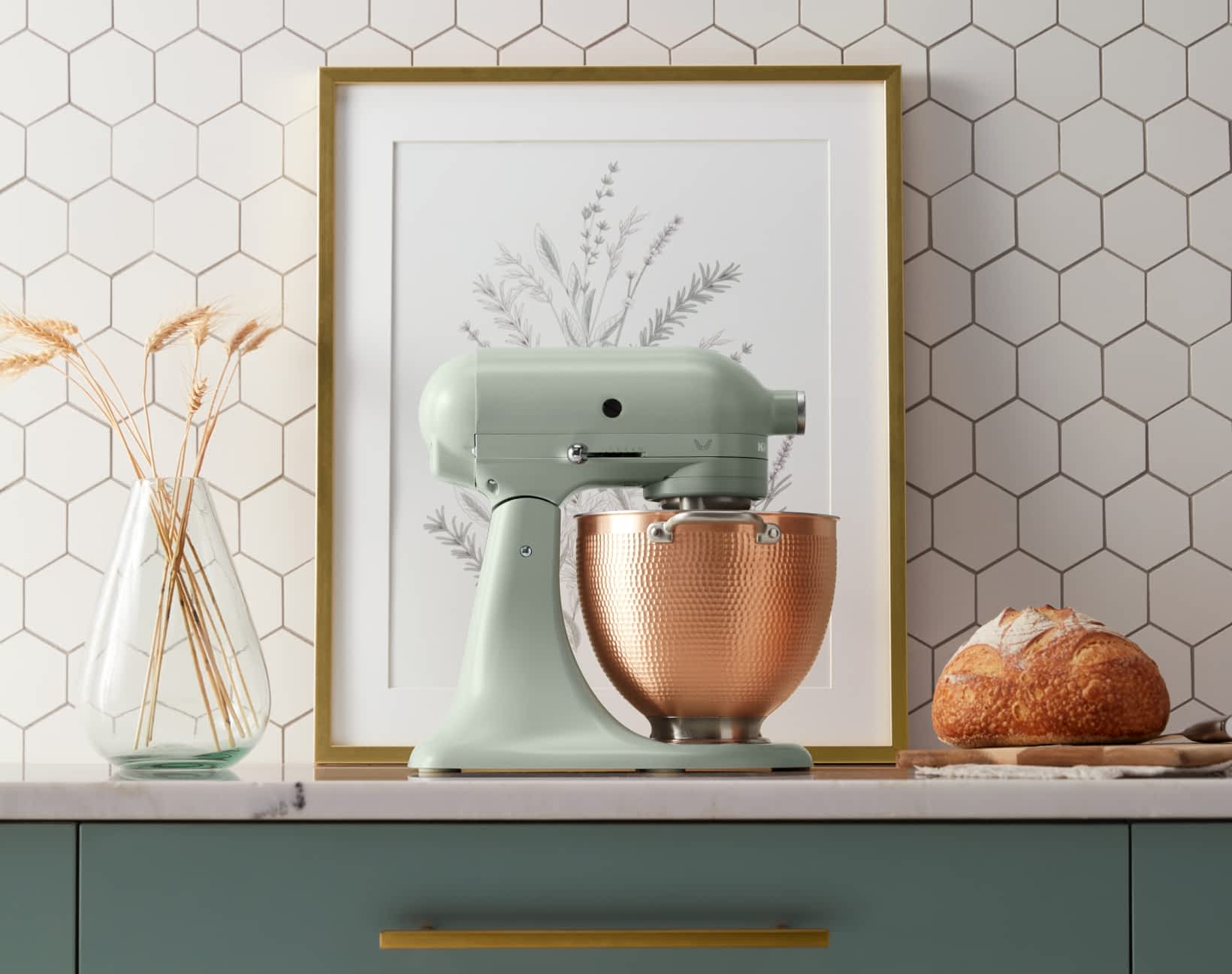 Blossom sitting on a modern countertop with botanical decorations.