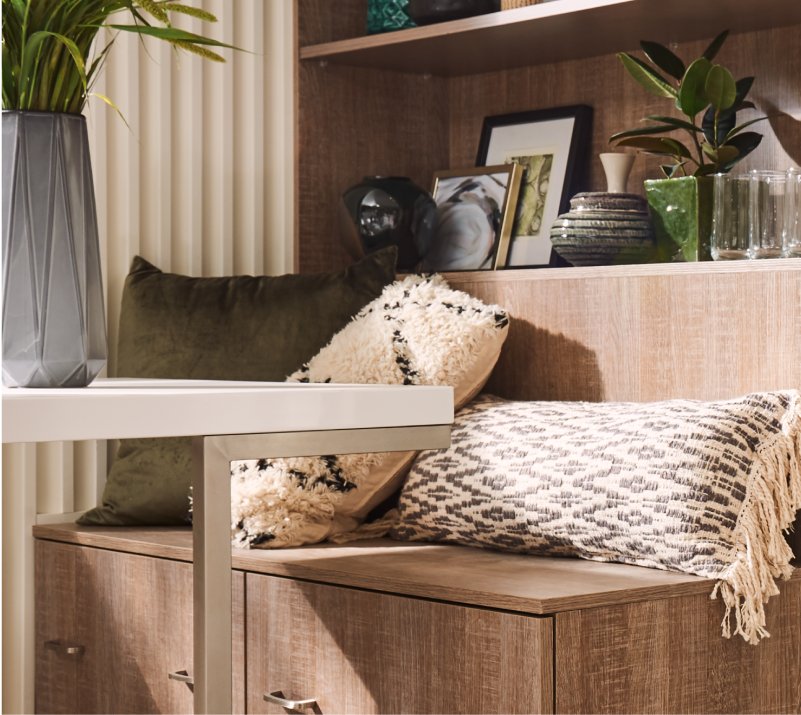 A bench covered in textured throw pillows.
