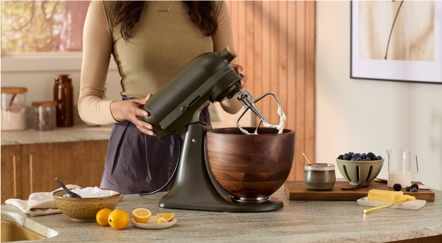 A person tilting the head back on their Evergreen Stand mixer.
