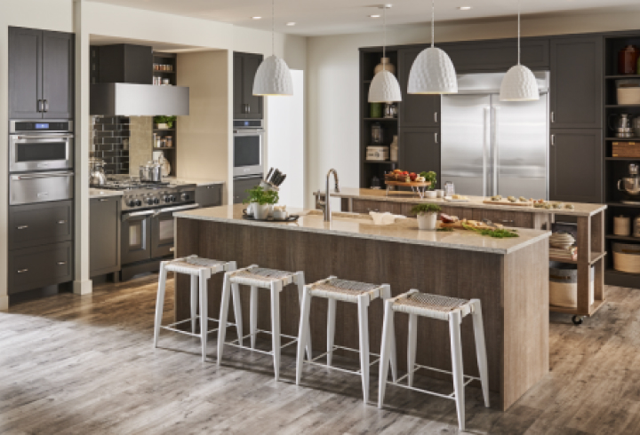 A modern kitchen with dark cabinetry and KitchenAid stainless steel appliances