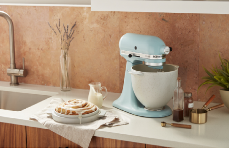 A pale blue stand mixer on a white countertop.
