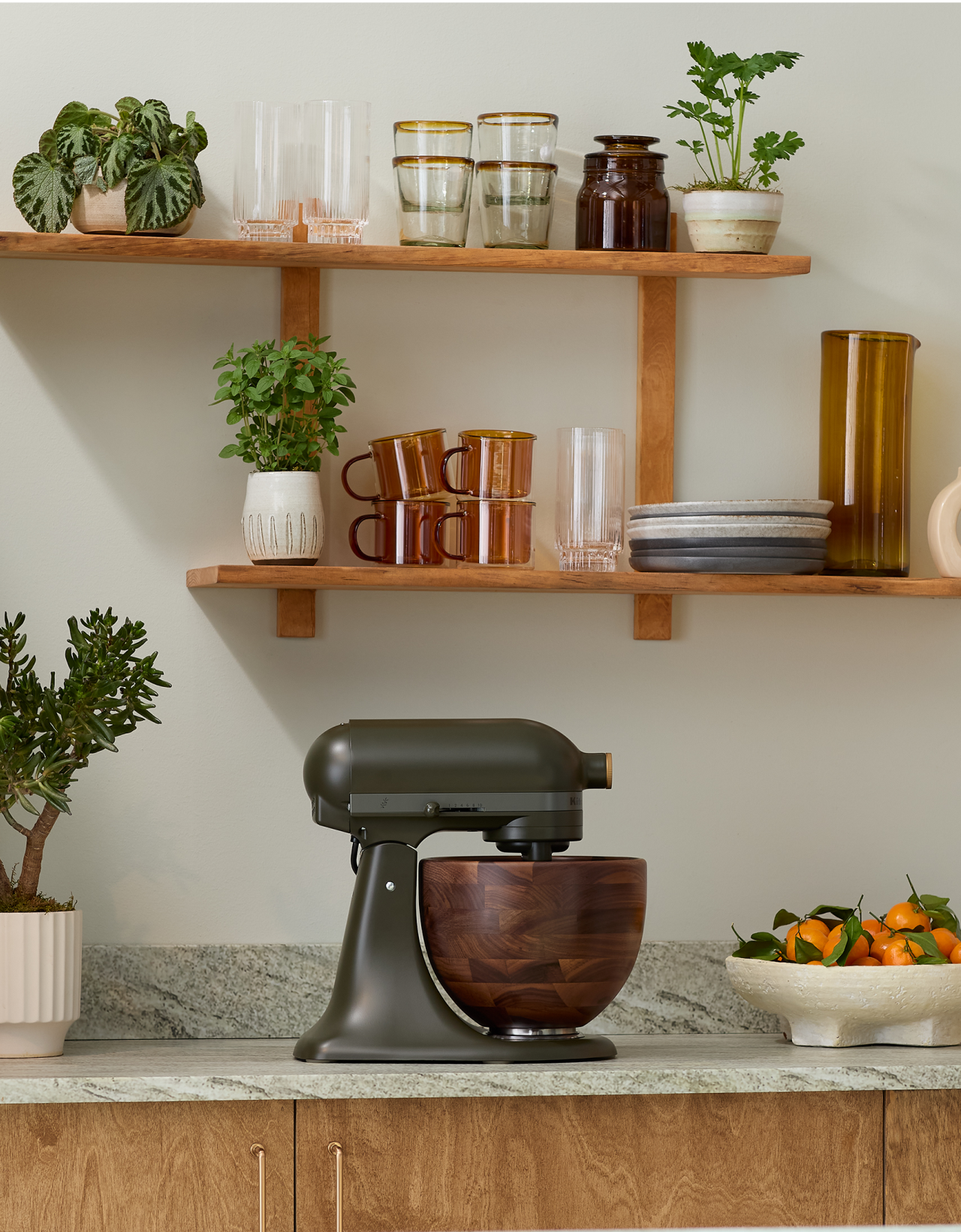 An Evergreen stand mixer sitting on a countertop.