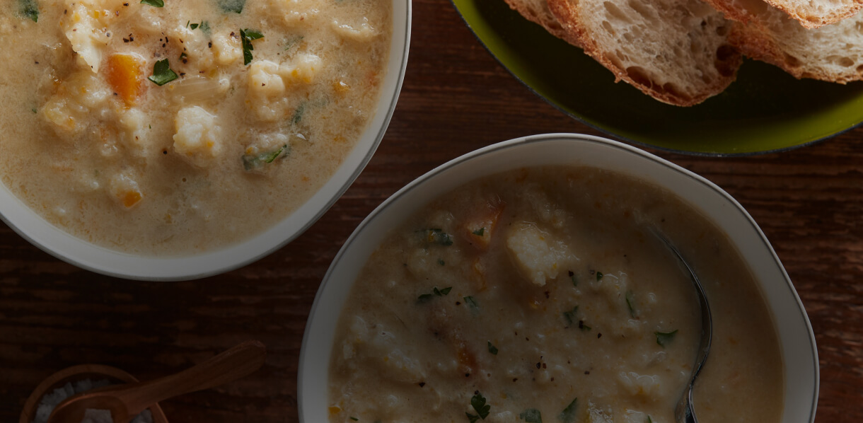 Bowls of soup served with fresh bread.