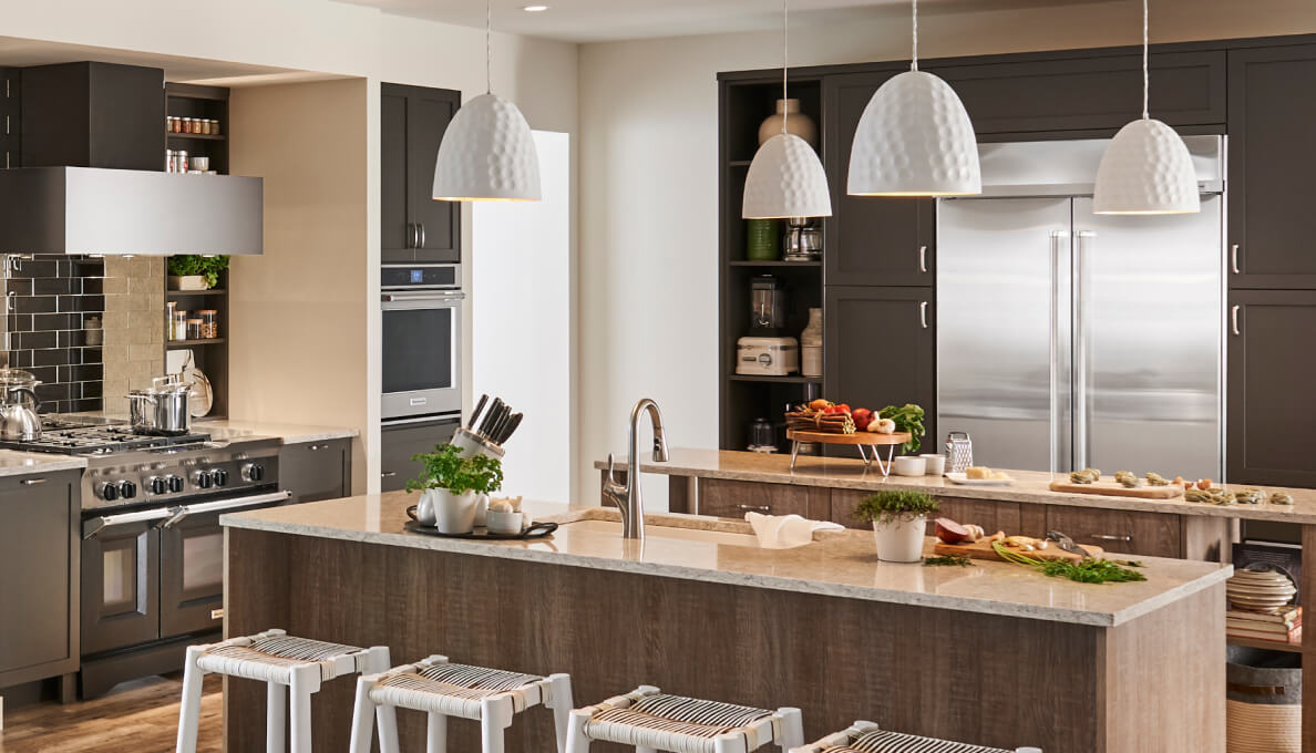 Large kitchen with built-in appliances and two islands.