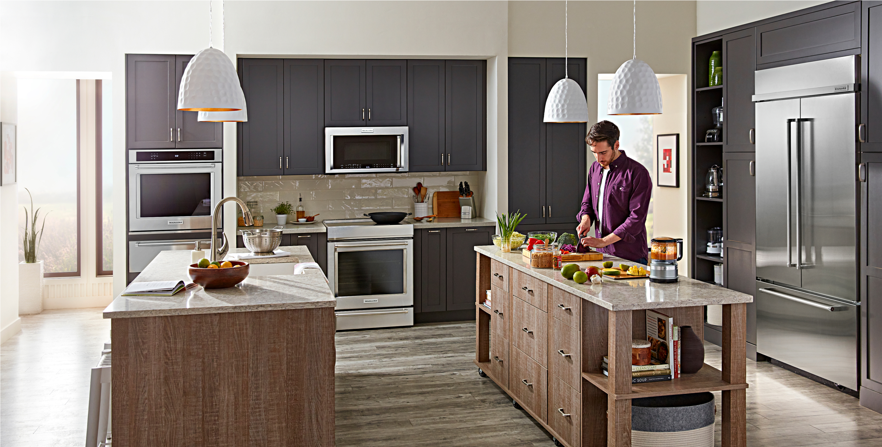 A large, open-concept kitchen filled with built-in KitchenAid® appliances. 