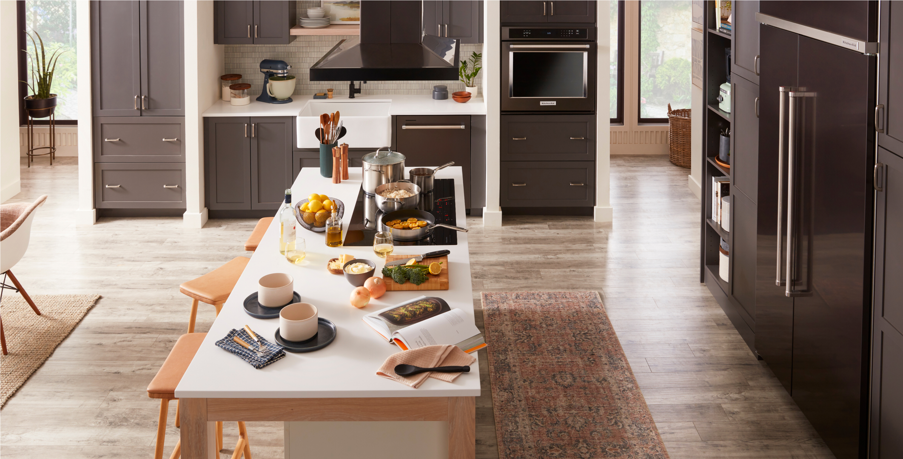 A warm, inviting kitchen filled with built-in KitchenAid® appliances.