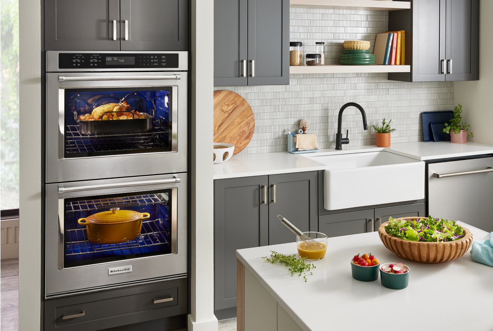 A double KitchenAid® wall oven cooking a roast turkey in the top oven and a dutch oven in the bottom oven.