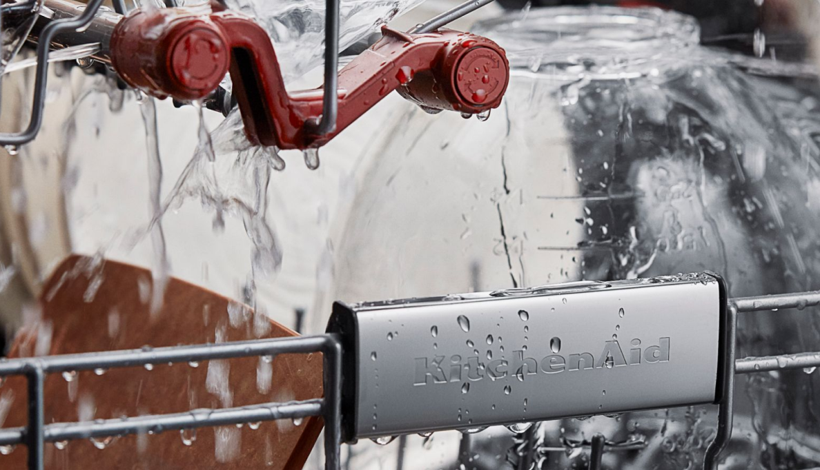 An interior shot of water flowing over dishes in a KitchenAid dishwasher.