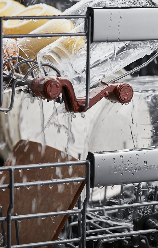 The interior of a dishwasher as it cleans.