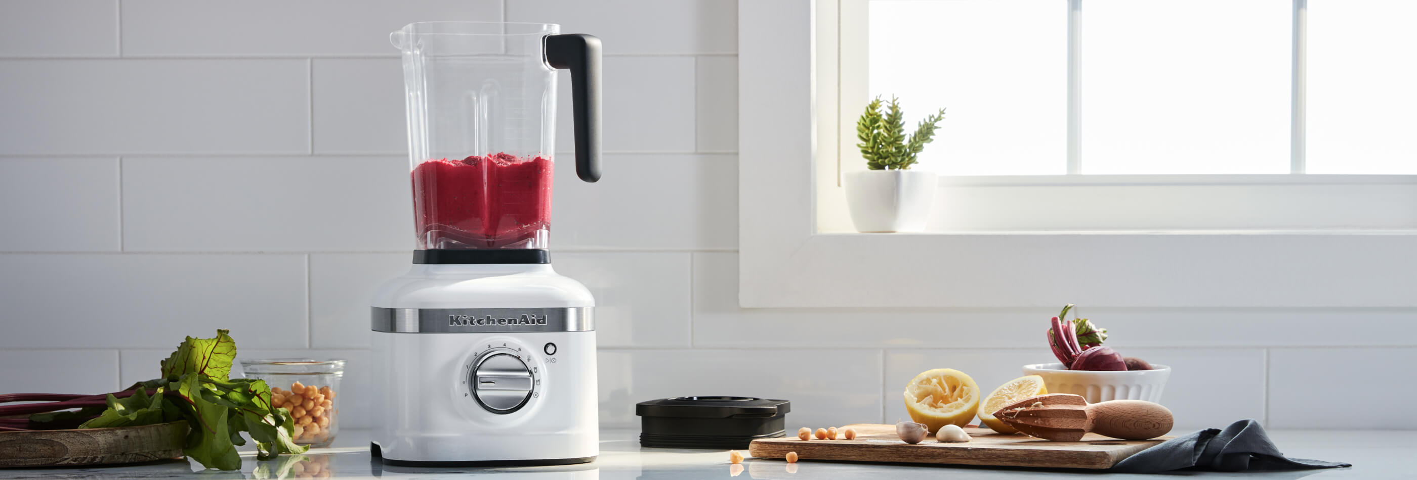 An open White K400 Blender resting on a white countertop.