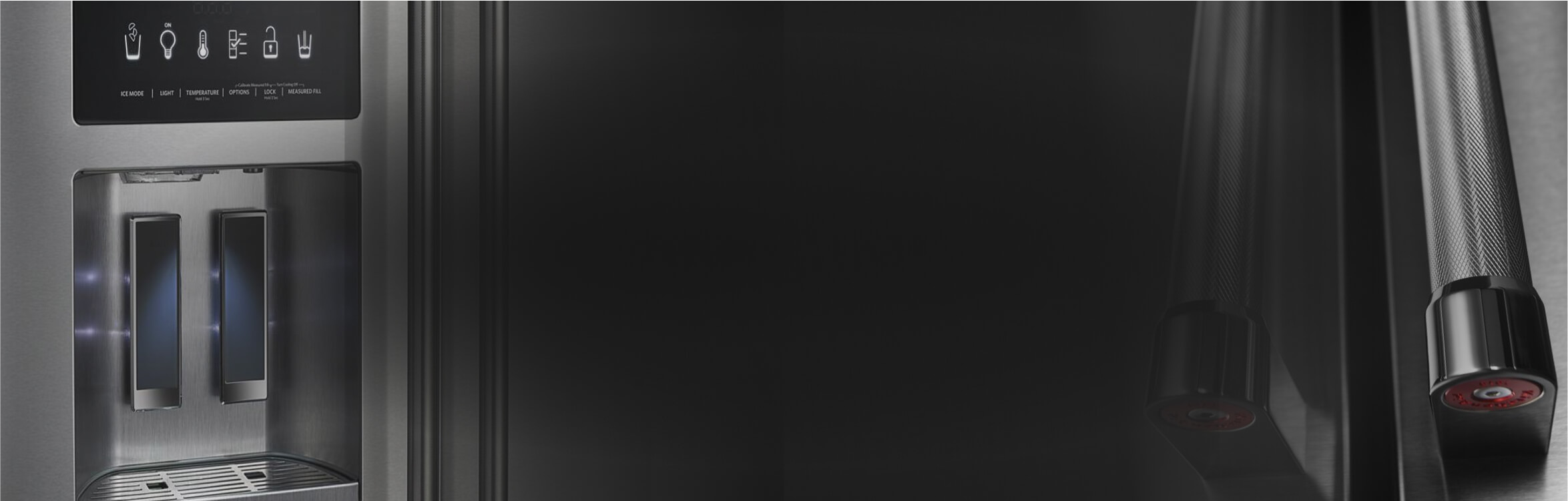 Close up of KitchenAid water dispenser on left and refrigerator door handles on right.