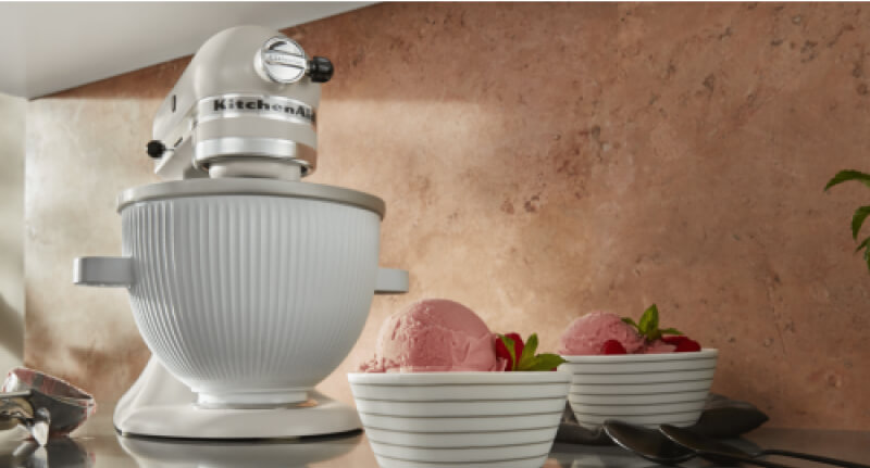 A KitchenAid® Stand Mixer using the ice cream maker attachment to make raspberry ice cream.