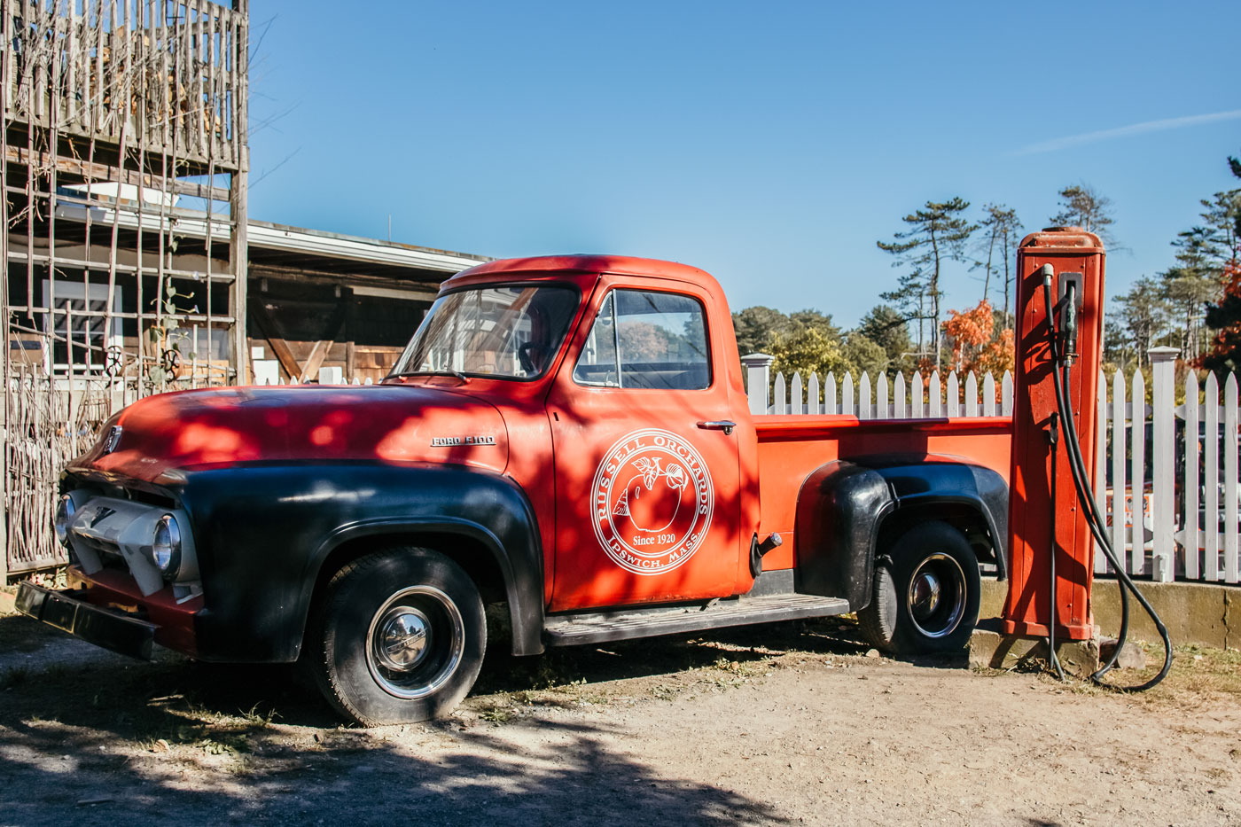 A red Russell Orchard pickup truck.