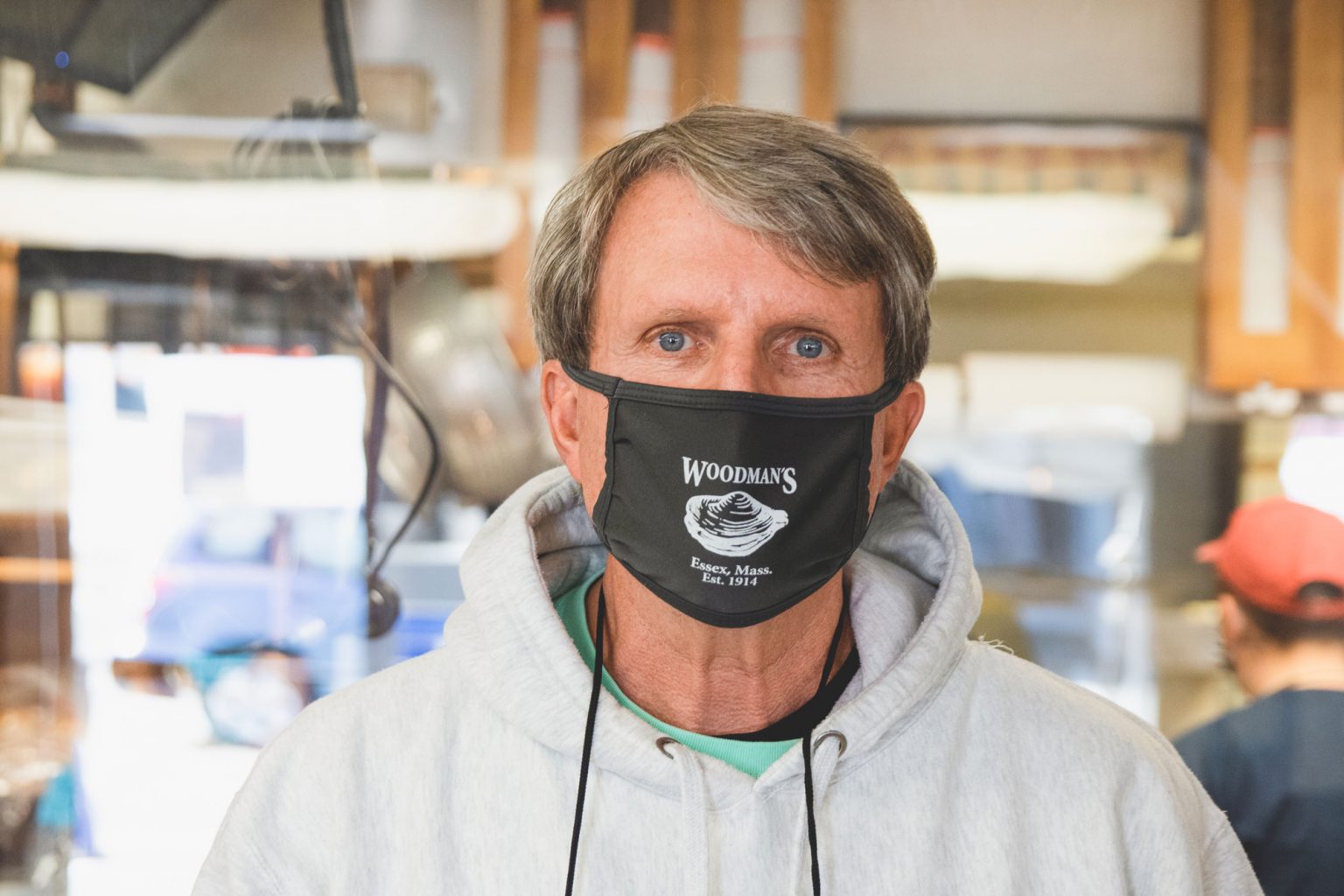 Douglas wearing a black face mask with the Woodman's Clam Strip logo.