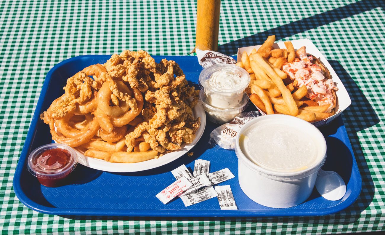 A tray filled with fried clams, french fries and other fried eats of Woodman's.