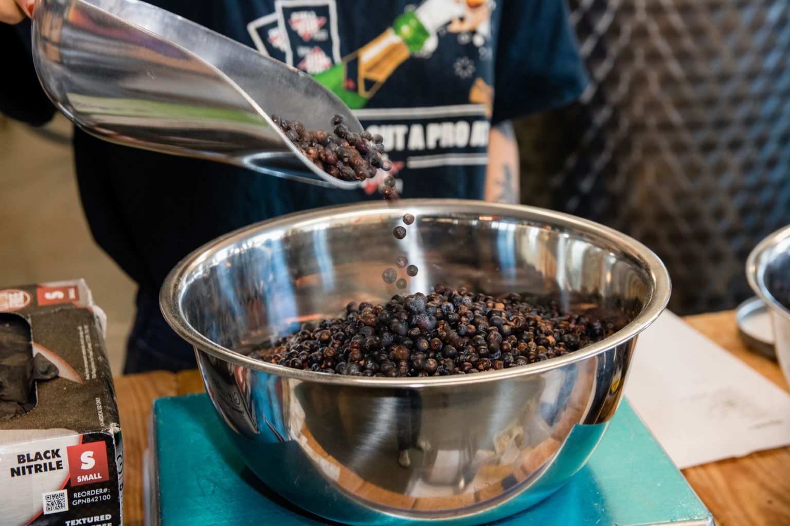 Dark herbs in a large metal bowl.