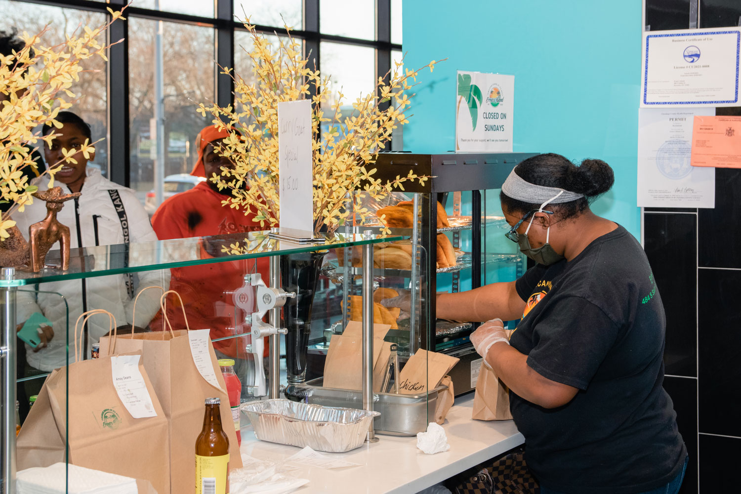 A woman filling out to go orders.