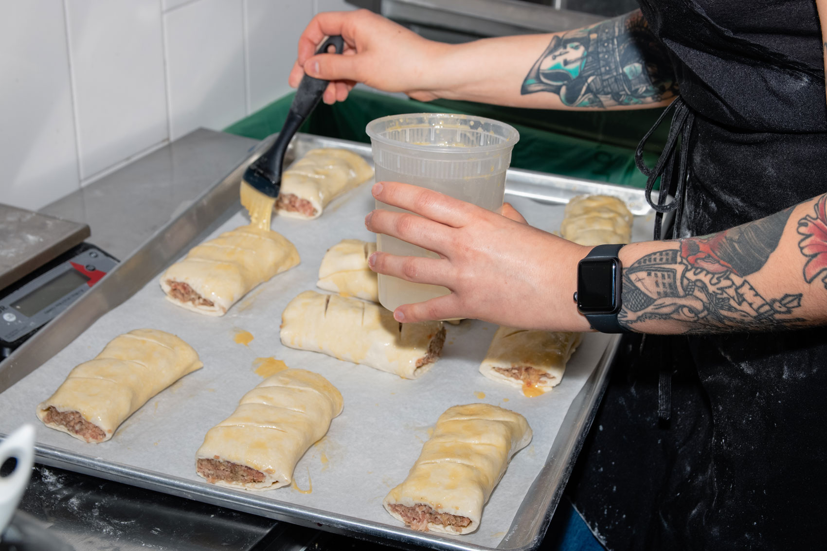 Small handheld pies being buttered.