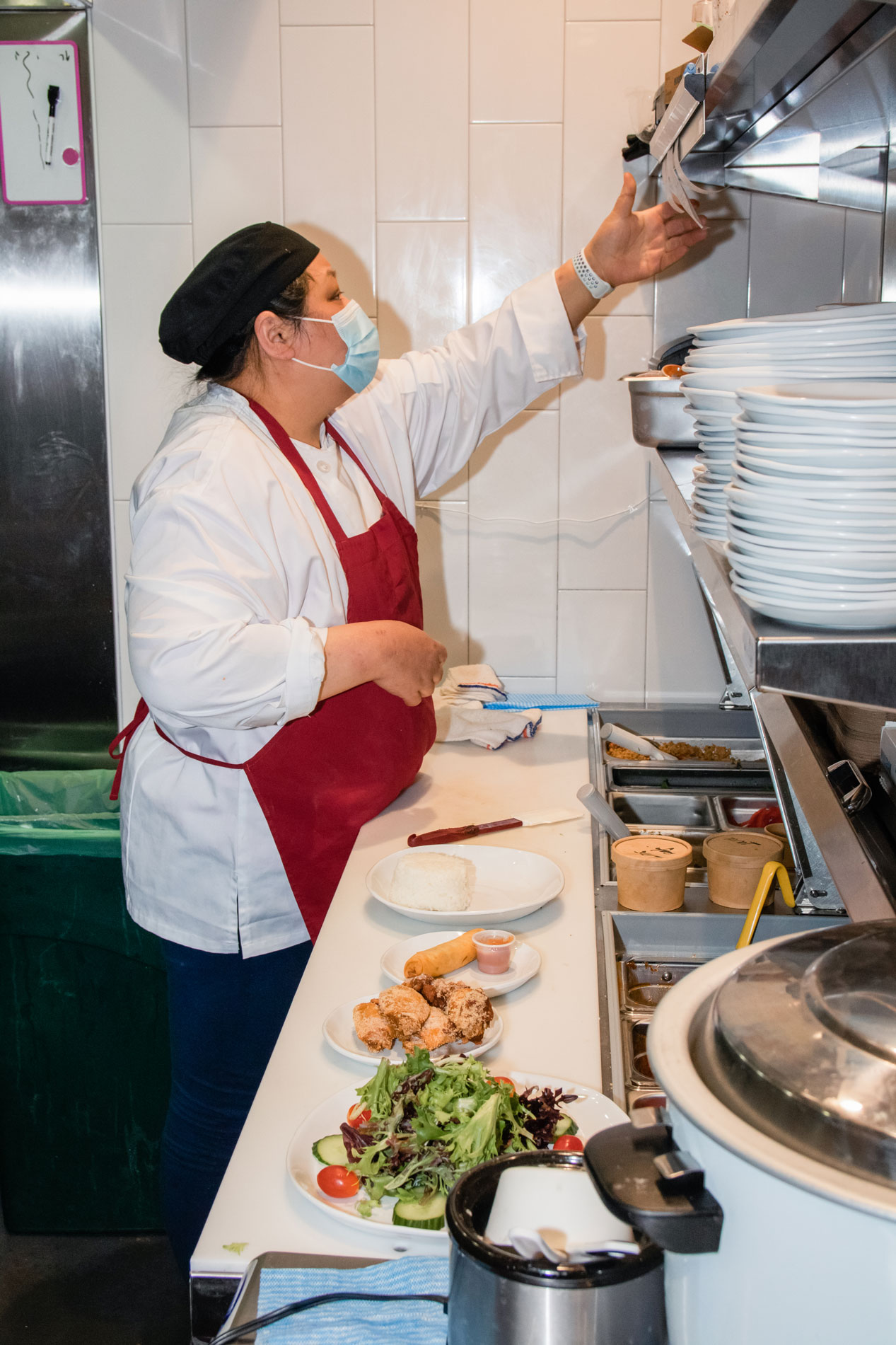 Sarinthra working in her kitchen.