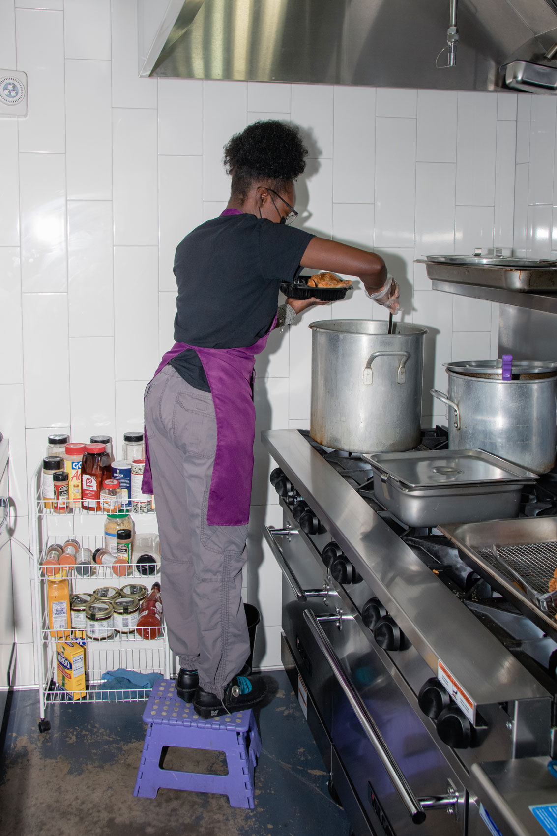 Dreamer serving food from a large pot.