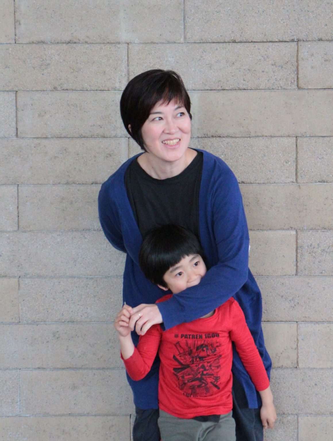 Takako Masuki playing with one of her children.