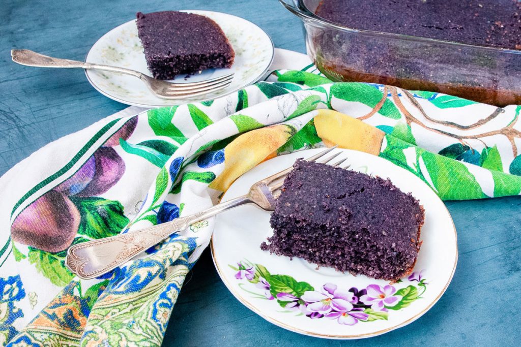 Slices of blue corn bread resting on delicate little plates.