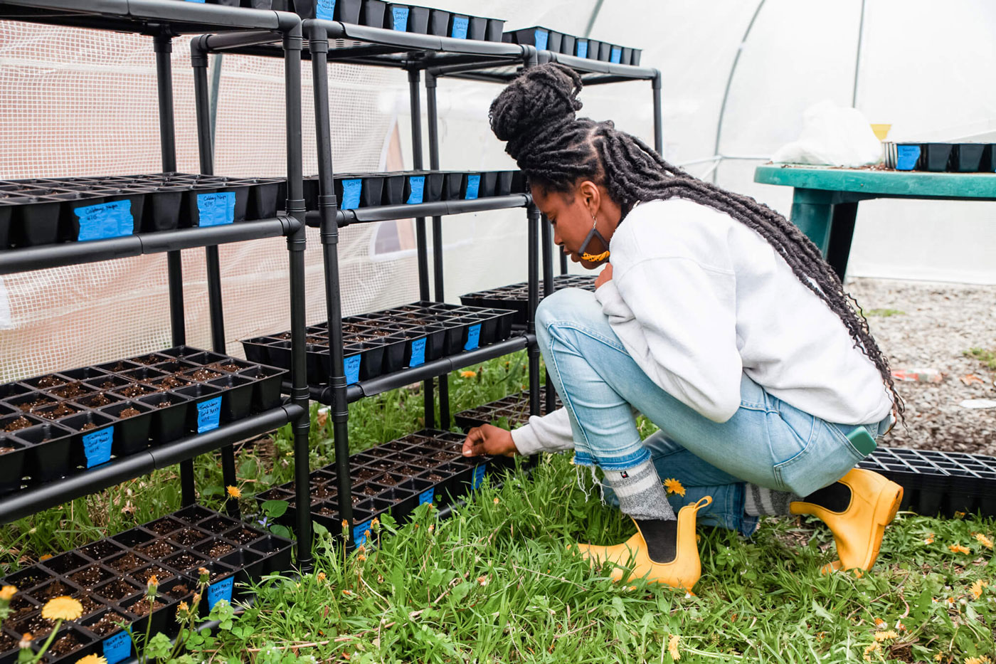 Christa tending to her nursery plants.