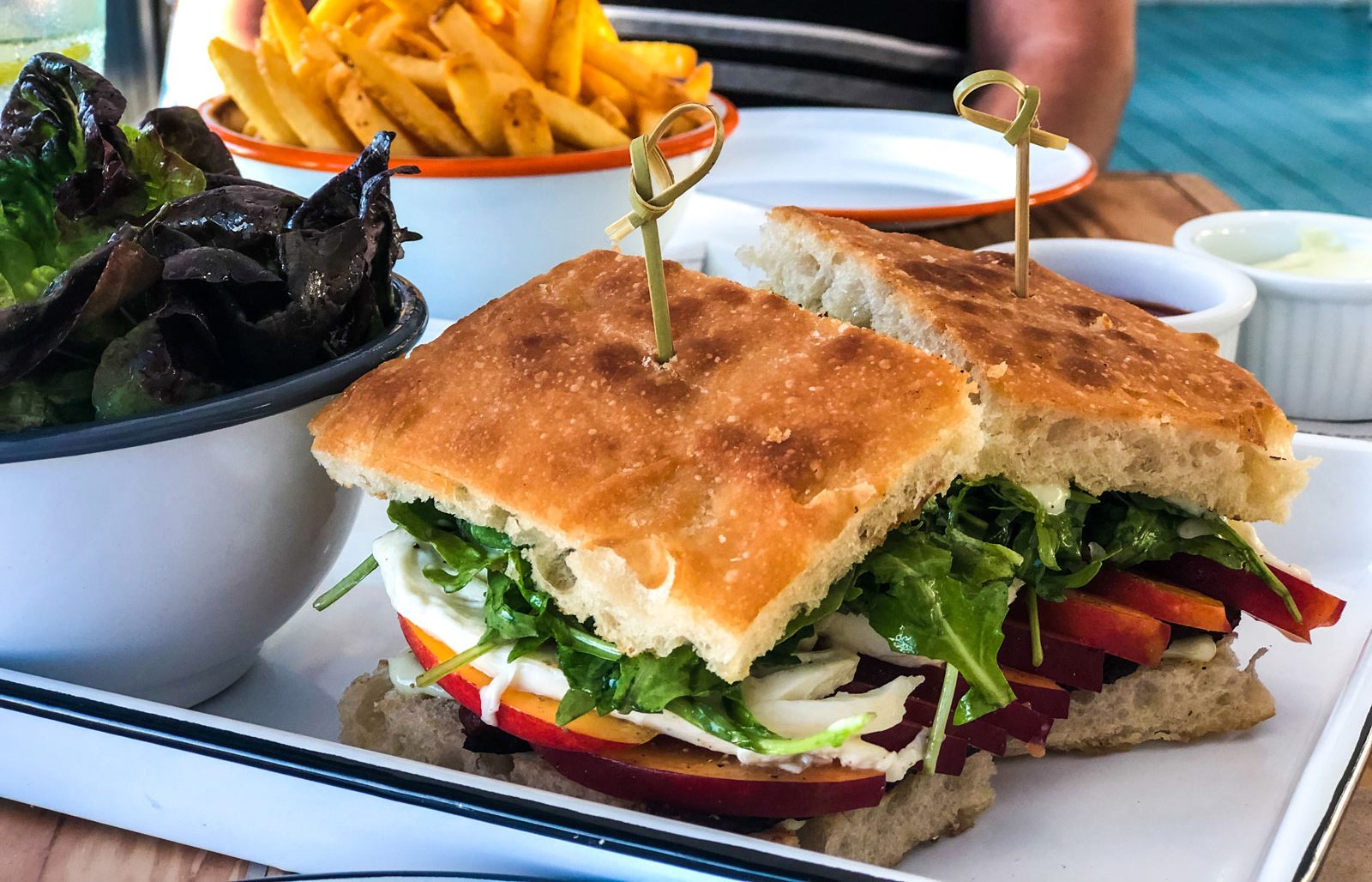 A fresh sandwich paired with a side salad.