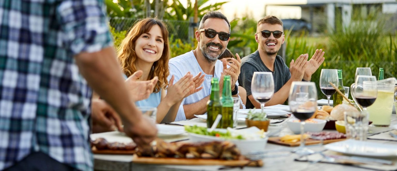 People applauding their cook.