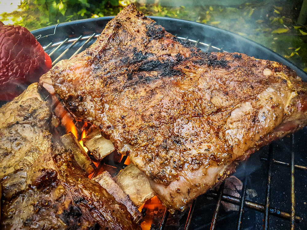 Ribs cooking on a grill.