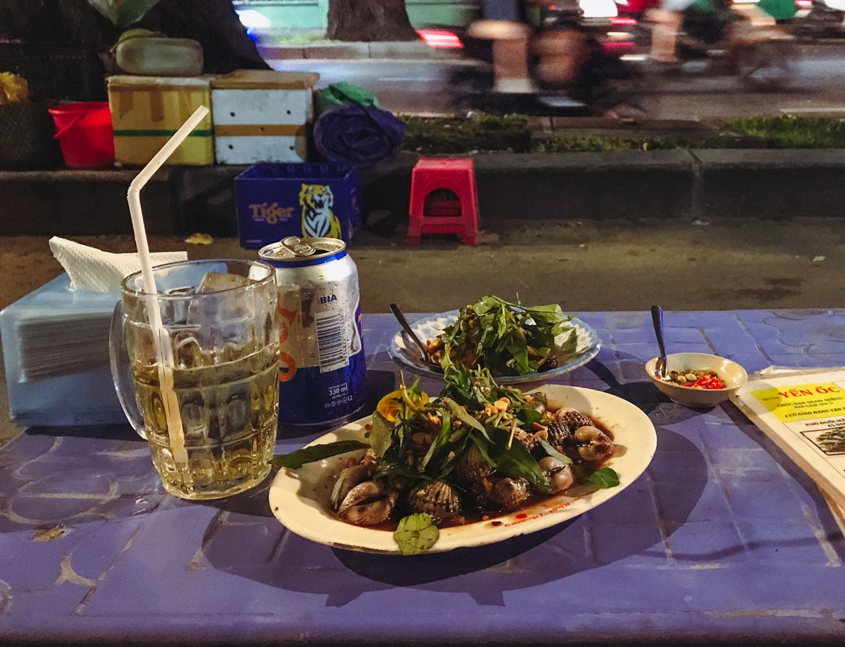 Two delicious dishes served with a glass of beer.