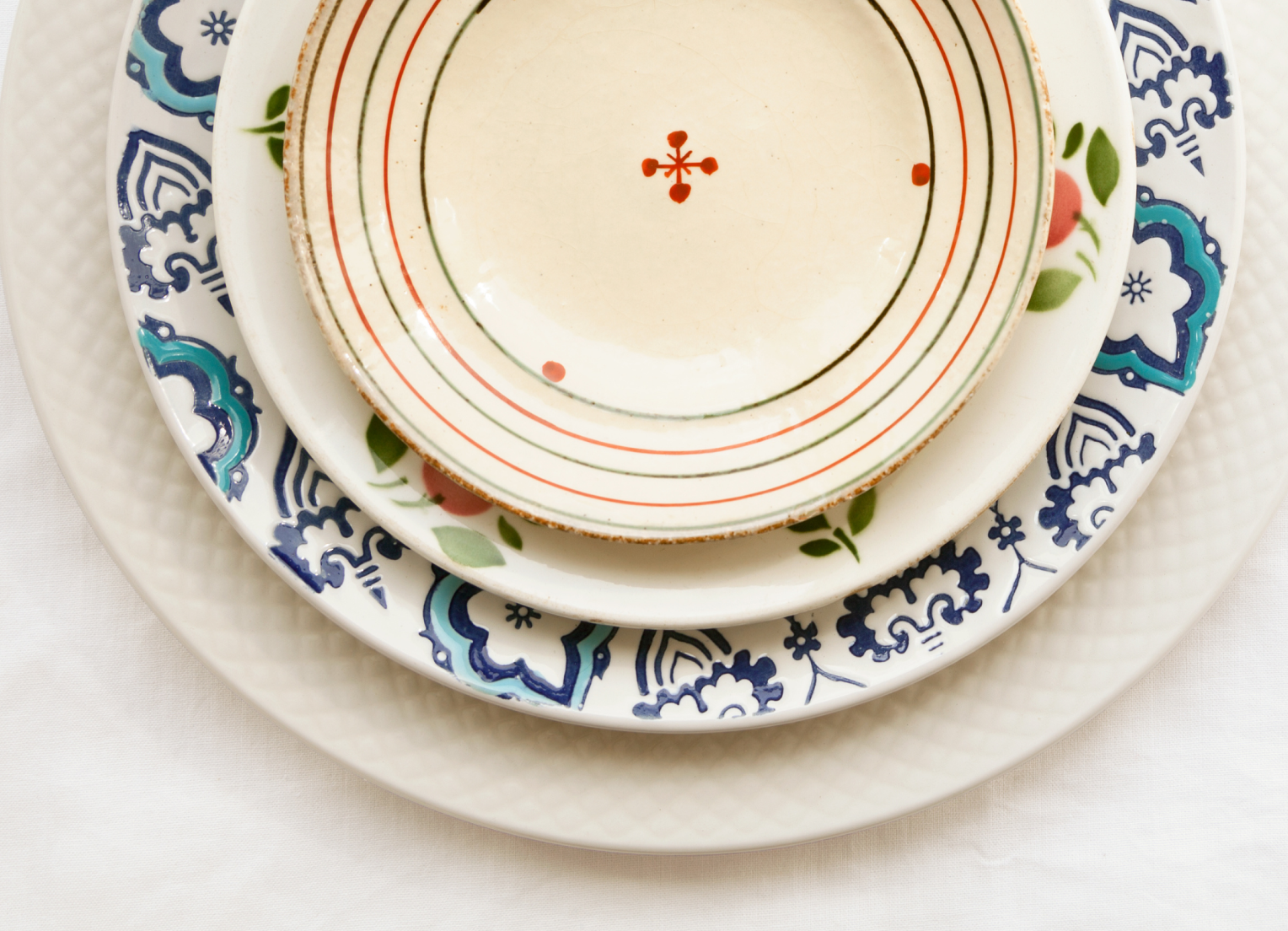 Stack of colorful, mismatched plates