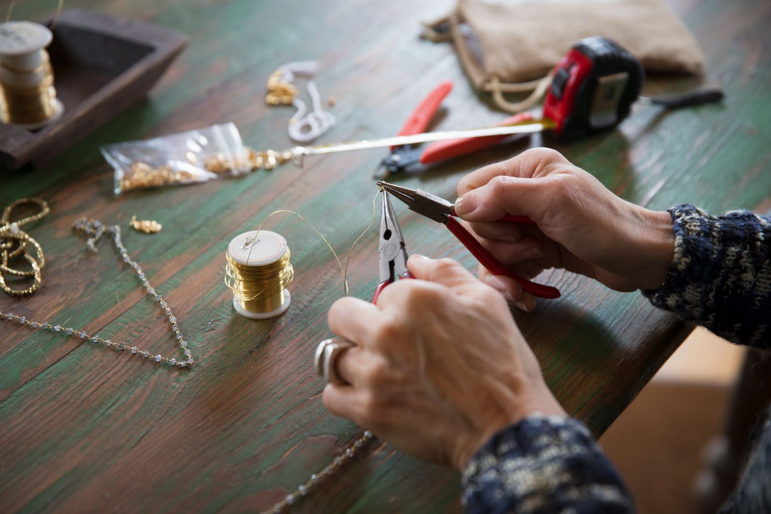 Skillful hands masterfully cutting delicate jewelry wire.