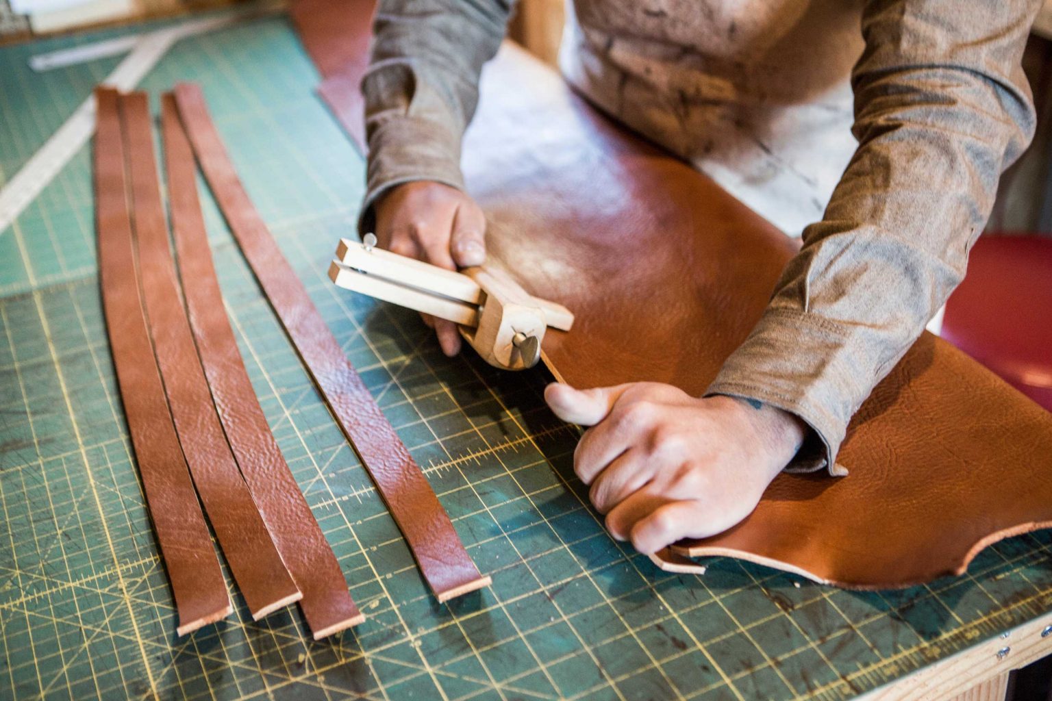 Strong hands working with tough, beautiful leather.