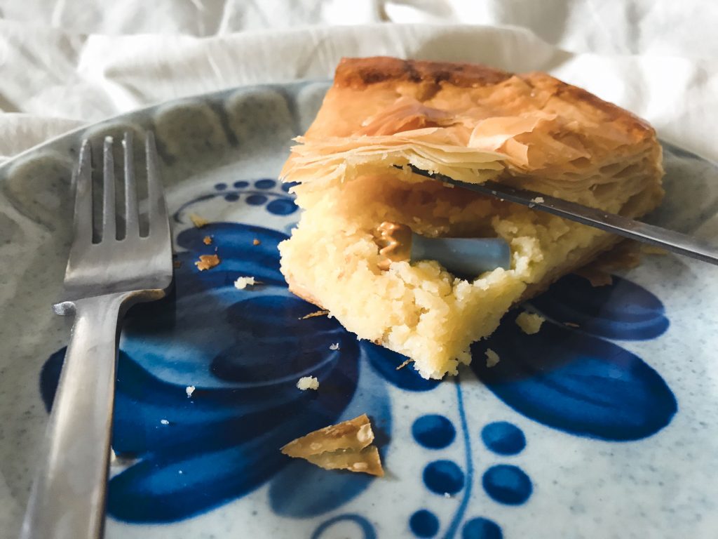 A porcelain fève resting inside a slice of galette des rois.