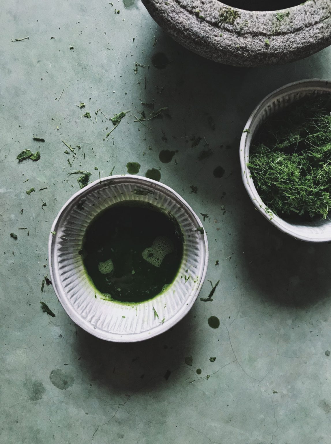 A ceramic dish holding a soft green liquid.