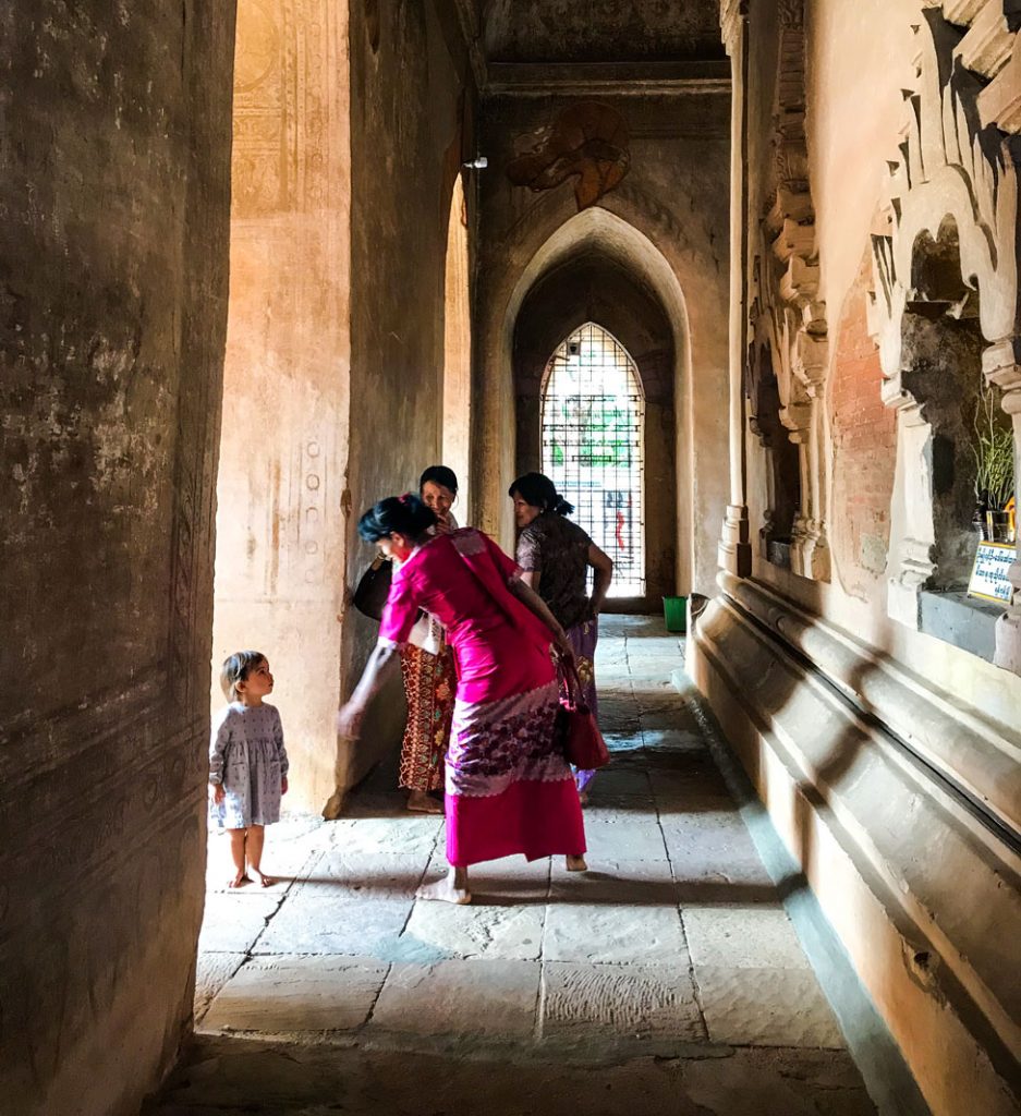 People barefoot in a temple in Myanmar.