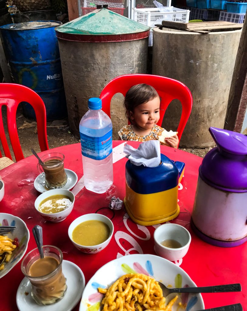 Wee Ling Soh's young daughter eating a piece of bread for lunch.