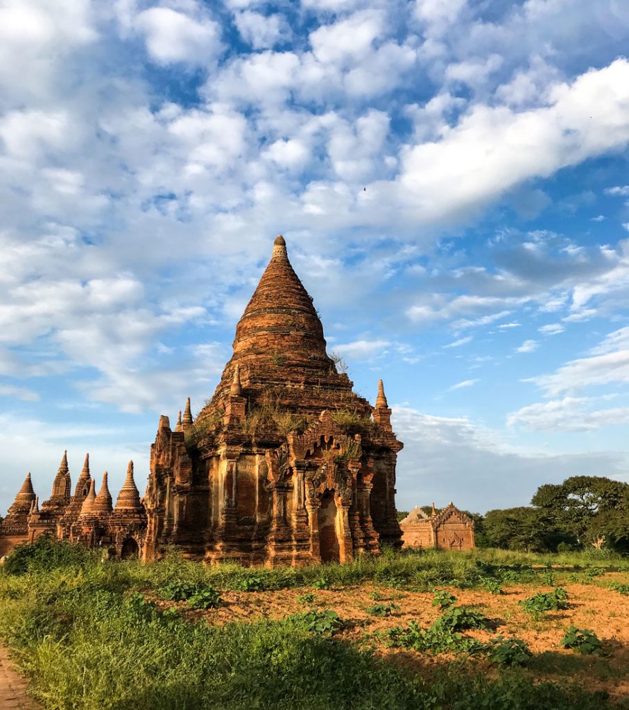 A view of ancient brick temples in Myanmar from a cart being pulled by a horse.